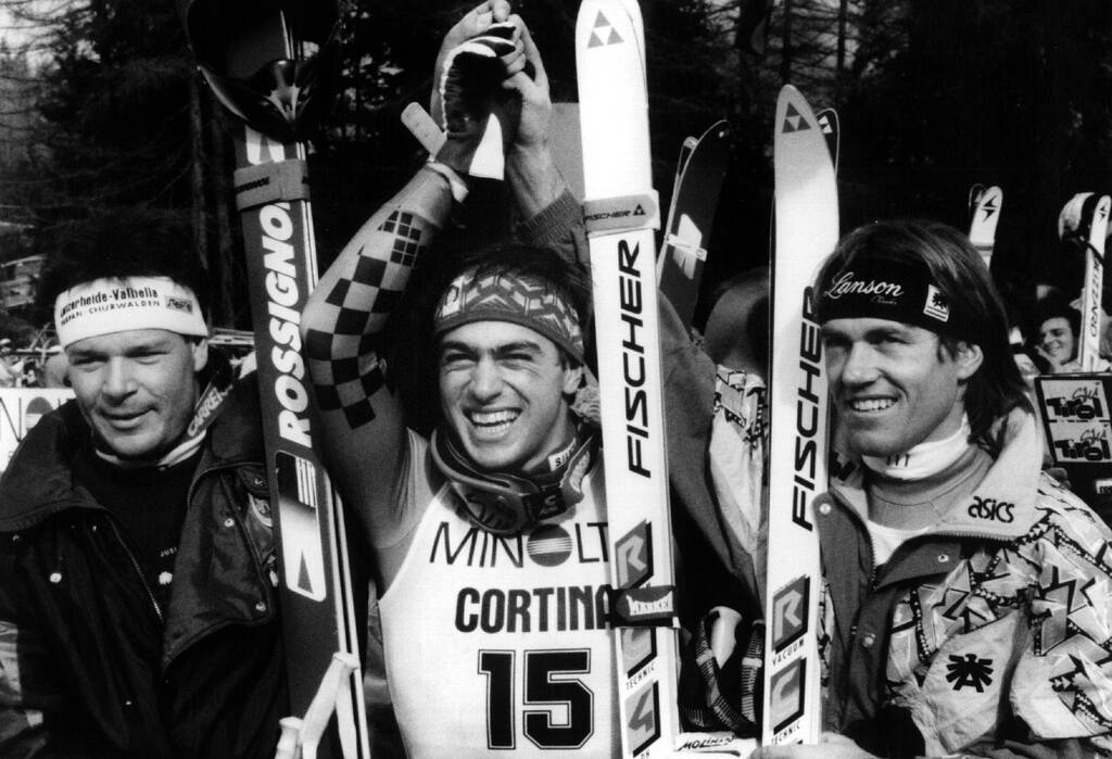 Cortina d'Ampezzo, Italia, febbraio 1990.Kristian Ghedina (ITA) vincitore della gara di discesa libera,festeggia sul podio con il secondo classificato,sulla sinistra, Daniel Mahrer (SUI) e Helmut Hoeflehner (AUT). (Pentaphoto)